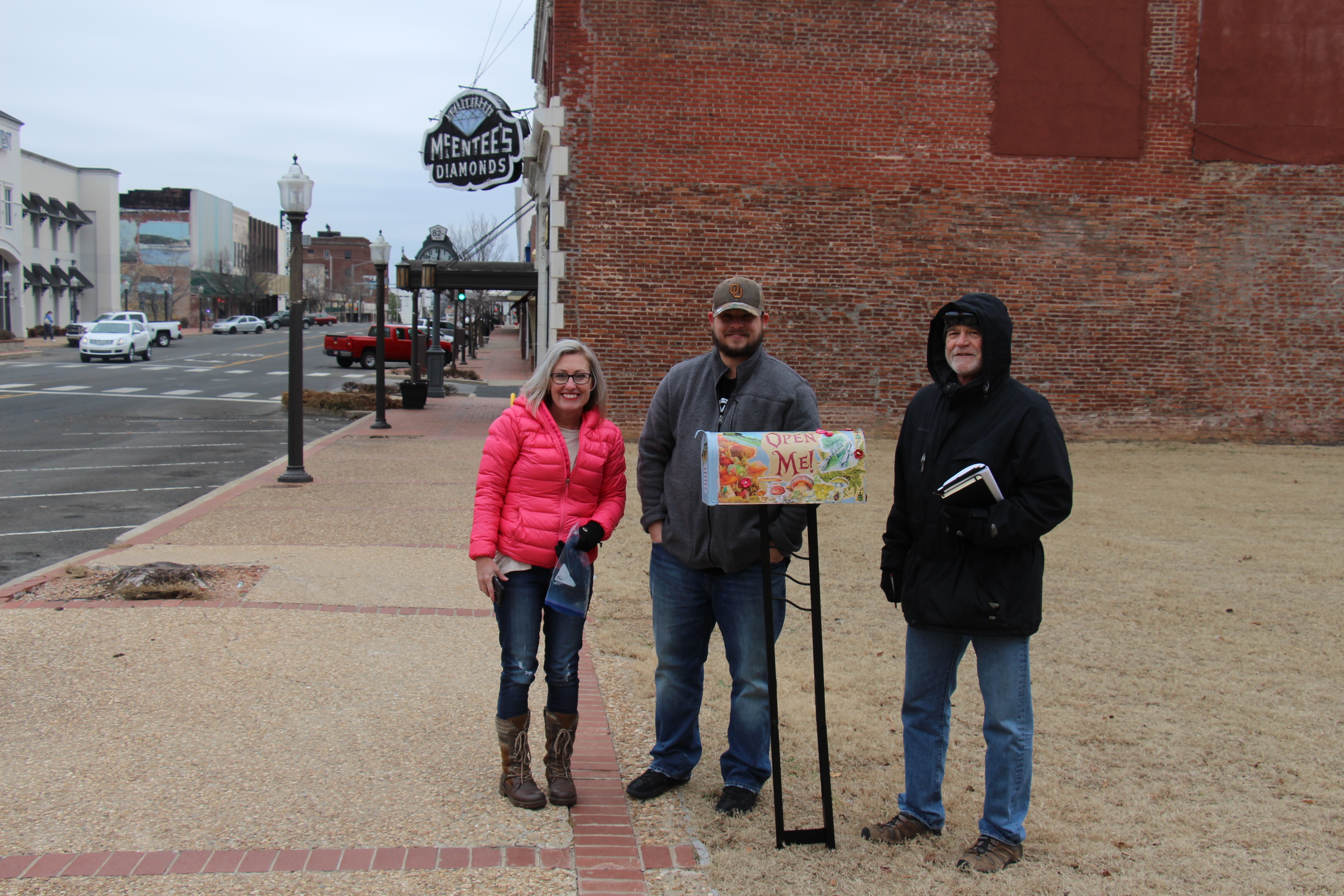 Robi, Kyle, and Greg standing by the artsy idea box for the Muskogee Green.